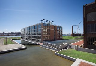 Green Light District - Photo 1 of 2 - The elaborate storm-water management system was engineered specifically for capturing and recirculating storm water from Building X (above). Two fish ladders and large expanses of restored salt marsh encourage wildlife to breed nearby. In the distance, the turbine spins animately beside the Forbes factory’s defunct chimney.