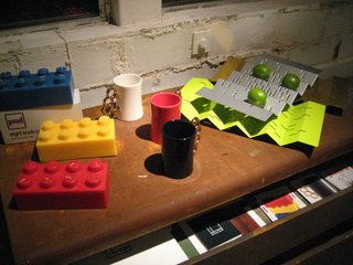Cool, colorful accessories from PAD Outdoor: 8 Knob Candles, Gold Knuckles mugs, and serving trays/fruit bowls.