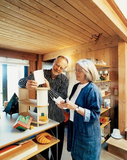 In the living room of their home at The Sea Ranch, Maynard Hale Lyndon and Lu Wendel Lyndon examine LyndonDesign’s new shelving system. Next to the system sits Maynard’s prized Cubicus by Peer Clahsen.