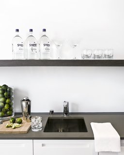 What started off as a decorating job in San Francisco's Pacific Heights neighborhood turned into a full-blown renovation by NICOLEHOLLIS. It also included the addition of a wet bar at the end of the kitchen. The happy-hour hotspot is equipped with a spout for filtered water, an ice maker, wine fridge, and a convenient over-the-sink shelf to house the booze. 