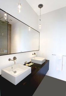 In the master bathroom, Hollis designed a custom floating oak vanity with two sinks, outfitted with Boffi fixtures.Photo by <br><br>Ben Mayorga Photography