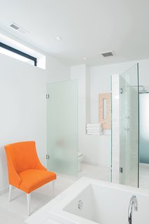 A onetime horse stable in Chicago underwent a modern renovation by Studio Gang Architects. The master bathroom, with its frosted glass walls and chair (rescued from the trash pile and rehabbed), is large and elegant enough to serve as a gathering place for parties. Read the entire article here.