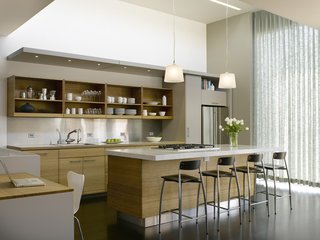 In the new kitchen, taking maximum advantage of the southern exposure was key. "I'm always conscious when doing townhouses about the fact that they limit daylight to only two directions," Willmer says. She raised the roof to a create a taller space and added a glass window for passive heating and lighting during the days.<br><br>Photo by Ken Gutmaker