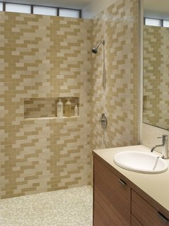 The Ellers wanted their main bathroom to be lined with tiles but the expense was a limiting factor. To overcome this, Katie made frequent trips across the Golden Gate Bridge to Heath Ceramics in Sausalito to purchase seconds. "She collected boxes and boxes over time, and then we arranged what she had in this pattern," Willmer says.<br><br>Photo by <br><br>Ken Gutmaker