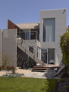 Willmer completely redesigned and re-landscaped the backyard. "Houses in the early 1900s were built with a strong presence to the street but the back was totally forgotten," she says. Now, Willmer admits, the house is almost more oriented toward the south-facing garden than the street, but it's a space in which she had more design freedom and that the family is able to enjoy to its fullest.<br><br>Photo by Ken Gutmaker