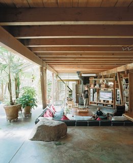Diamond in the Rough (and Ready) - Photo 6 of 13 - Rocks dug up during construction were saved and incorporated into the poured-concrete floors and walls. Hydronic heating coils in the floor are augmented by a wood stove during the damp winters.