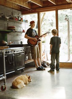 Diamond in the Rough (and Ready) - Photo 7 of 13 - Cody, 17, and Dylan jam in the kitchen with Yogi, the Welsh corgi.