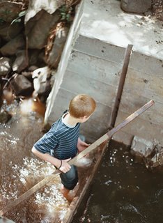 Diamond in the Rough (and Ready) - Photo 13 of 13 - The young Meffans relish playing in the creek’s adjustable dam, made from poured concrete. The nutrient-rich silt that collects over the summer is dumped on the vegetable garden in the winter, when the creek flows freely.