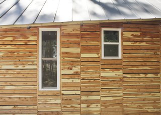 The students also attempted to appease residents by making their home "of the area." They based the design on vernacular shotgun houses and bought the cedar siding as off-cuts from a local lumberyard, which totaled $120.<br><br>Photo by <br><br>Ty Cole