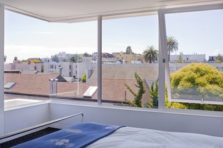 One of the goals of the renovation was to open up the space to the surroundings. "The old master suite was totally bizarre with its back to the view," Samaha recalls. The bathroom, then located where the master bedroom's wall of windows is now, had but a tiny opening to the outside. Samaha and Hart flipped the placement of the bathroom and bedroom and installed a corner glass window in the latter.<br><br>Photo by <br><br>Sharon Risedorph