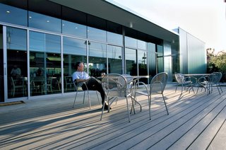 Ronde outdoor stacking chairs, from Design Within Reach, are situated on the deck off the living room.