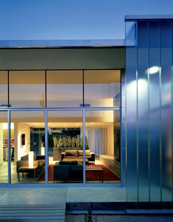The architects kept the furniture simple, light, and off the floor. "We really saw this as an opportunity to soften some of the edges of the house," Jack 3 says. The result is a space filled with both mid-century classics and newer selections in the same vein. The Neo sofas are from Design Within Reach.