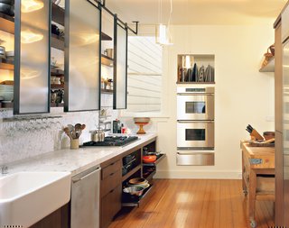 6 Simple Ways to Save on Your Kitchen Renovation - Photo 6 of 6 - Prized possessions such as the old English butcher block sit cheek-to-jowl with 21st-century amenities, such as the stacking ovens by Dacor, six-burner Viking stove, and Miele dishwasher.