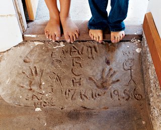 Madeline and Gabriella check out the handprints of their grandmother and granduncle, which were cast in the original foundation in 1956.