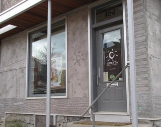 The entrance to Oresta's organic skin care confectionary. To the right of the door is a list of every recorded owner of the businesses the building has housed since the turn of the century, based on the couple’s title and historical research.