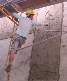 Griffin carves an exterior panel using a casuary bird femur bone knife—a dedication to early artistic tools and methods. Each panel received a fresh topcoat of concrete, after which the artist had no more than 15 minutes to make his marks before his canvas completely hardened.