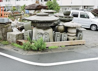 Small Box Home with Black Metal Facade in Japan - Photo 2 of 14 - Local stonemasonry, displayed across the street from the house.