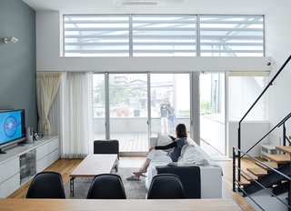 Small Box Home with Black Metal Facade in Japan - Photo 6 of 14 - The family's hub is a high-ceilinged main room on the second level. It's open and casual and gets lovely morning light.