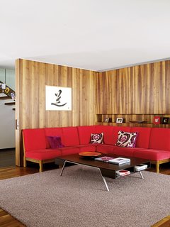The red sofa in the living room is a 1960s piece originally owned by Strolz’s parents.