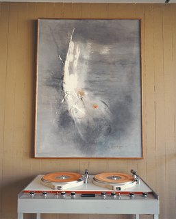 Stevens pared down his collection of vintage furniture and art considerably when he bought the Opdahl house, but he saved critical pieces such as this Gene Cooper painting.