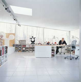 Roll of tracing paper in hand, Aarnio contemplates his next move in his home office addition.