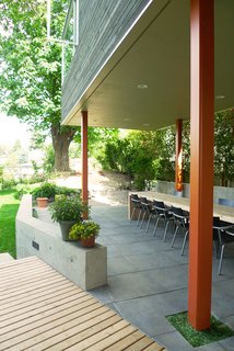 Bedroom Addition in Seattle - Photo 9 of 16 - A view of the the covered dining area after the renovation. The master suite is above.
