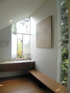 Bedroom Addition in Seattle - Photo 11 of 16 - Linear elements like the dressing bench and sink counter connect the areas of the new master bathroom.