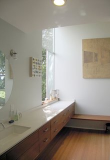 Bedroom Addition in Seattle - Photo 13 of 16 - The view from the shower is oriented toward the corner focal point, where the dressing bench and sink counter meet and the window opens up to the outside.
