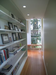 Bedroom Addition in Seattle - Photo 14 of 16 - A long bookcase connects the master bathroom to the bedroom.