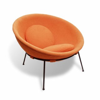 Bo Bardi’s Bowl chair, designed in 1951 of iron and aluminum, with orange fabric.