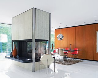 "On a bright day, you have to wear sunglasses in here," Mandolene says. A freestanding travertine-and-steel fireplace, open on all four sides, divides the living and dining areas.