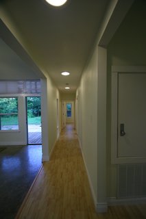 Inside the front door, a long hallway separates the public space, on the left, from the private space, which extends farther back on the right side of the home. Photo courtesy of Jared Boudreaux and Tim Hayes.