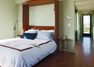 The bed folds vertically into the wall to open up the living space for lounging or entertaining.
