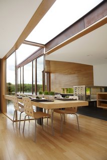 The table in the common area, which continues the FSC-certified maple used throughout the interior, is mostly used for dining and serves as the hub of the house.