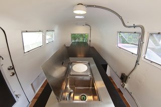 The steel lid opens up at one end of the island to reveal a sink and hot plate for cooking a meal. Photo by Sadamu Saito.