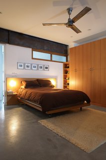 Both the kitchen and the main bedroom blend polished concrete with white oak cabinets. Fleming spent almost six months building the house’s millwork, which lends the house a warm, bespoke quality.