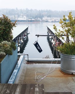The jerry-rigged pulley system hoists the newspaper up to the roof.