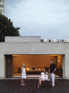 The family makes ample use of the rooftop deck, which sits just off the master bedroom. Piti and Helena share a Hee lounge chair by Hay.