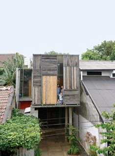 The sliding wood partitions on the upper floor help shield the master bedroom from the strong tropical sun.
