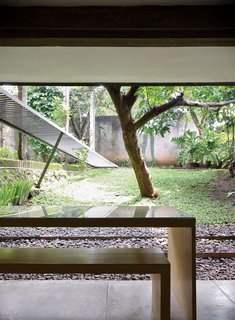 The new kitchen opens out completely and magnificently into a sloping garden. There is no wall, no door, no windows, nothing: just straight out into the yard.