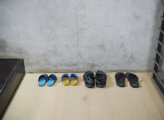 Little fits the extreme indoor-outdoor living of the family better than an accessible spot for their sandals.