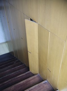 Because keeping tidy with a pair of young boys bustling about can be something of a headache, this clever storage option tucked alongside the stairs is both useful and a nod to the house's clean aesthetics.