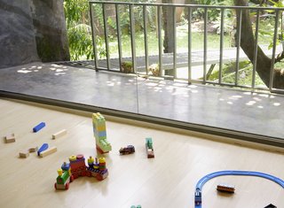 The family room upstairs is the heart of family live at the Wisnu residence. The view to the private backyard gives a sense of serenity, even if the kids' toys find their way across the floor.