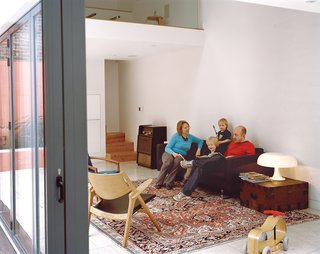 The glass walls that separate the living area from the courtyard fully retract to allow a smooth passage between the two.