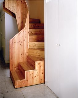 The staircase is a bespoke design by Luke Tozer, made of a larch composite sourced from sustainable forestry in Austria. It was made off-site and then assembled in position like a jigsaw puzzle.