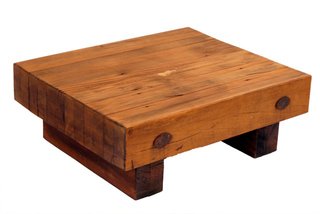 Motta designed the blocky Caju side table with a square top, then began offering it with a round top. In the Espasso showroom, the square versions are multiplied and placed together to show the different wood grains.