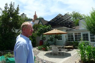 Begley demonstrates how his solar panels are angled to take full advantage of the sun's path.
