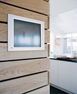 A computerized control panel in the hallway allows the family to monitor and control the house’s energy consumption.