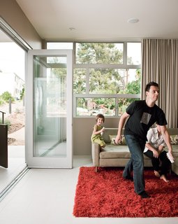 An Ikea rug and Deep Sectional sofa from Room Service set the scene in the Owens household.