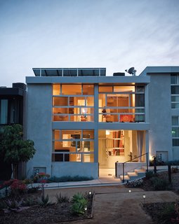 Architects Ana Henton and Greg Williams broke up the uniformity of the seven town homes by making a feature of the Jeldwin dual-glazed windows, laid horizontally here and vertically on the neighboring units.